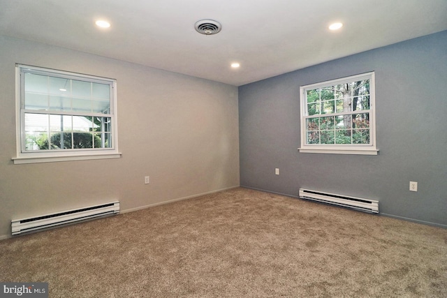 empty room with carpet floors and a baseboard radiator