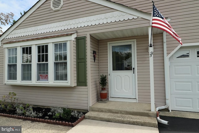 view of exterior entry featuring a garage