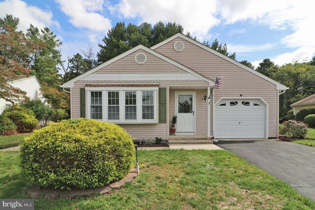 view of front of property with a front lawn and a garage