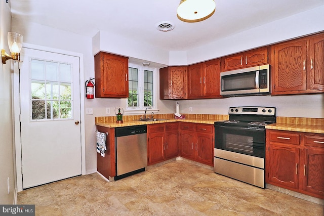 kitchen featuring plenty of natural light, sink, and stainless steel appliances