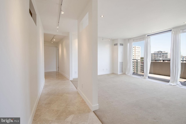 corridor with rail lighting and light carpet