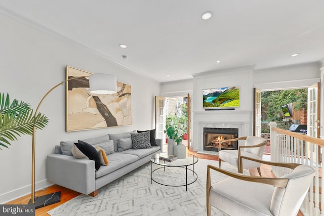 living room featuring crown molding and light hardwood / wood-style flooring