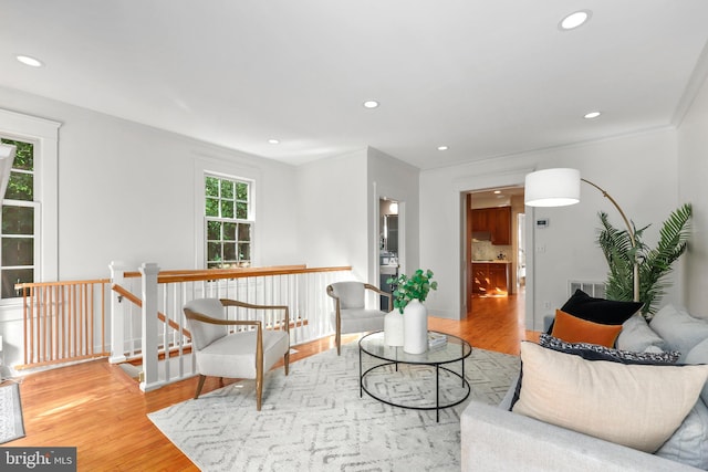 living room featuring crown molding and hardwood / wood-style floors