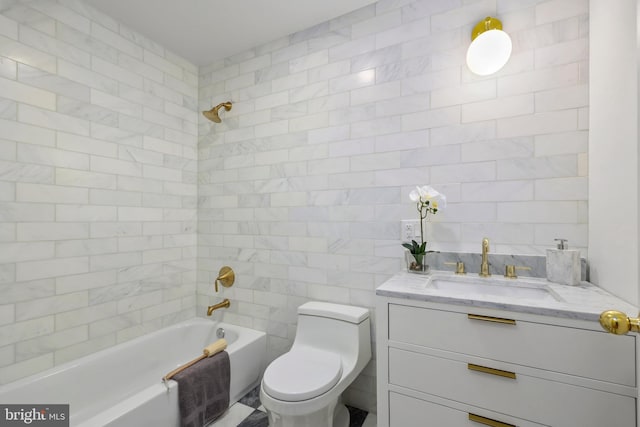 full bathroom featuring vanity, tiled shower / bath, toilet, and tile walls