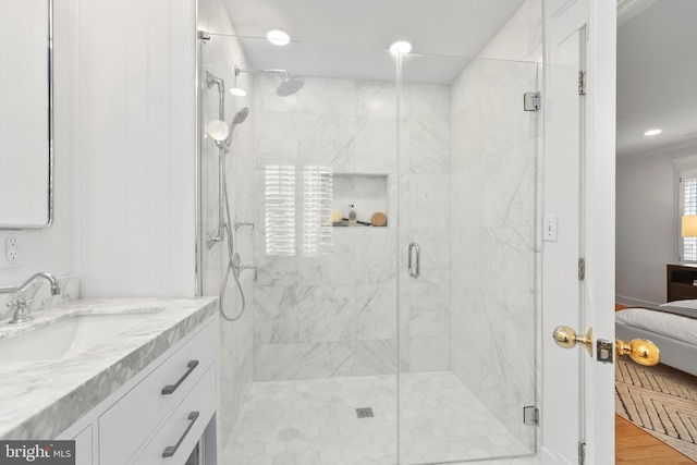 bathroom with vanity, an enclosed shower, and wood-type flooring