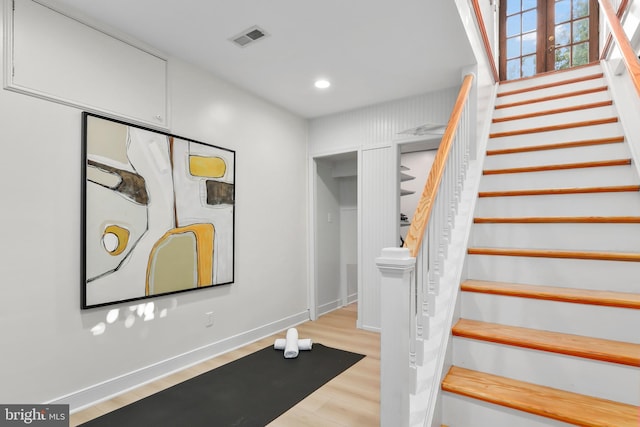 stairs featuring wood-type flooring