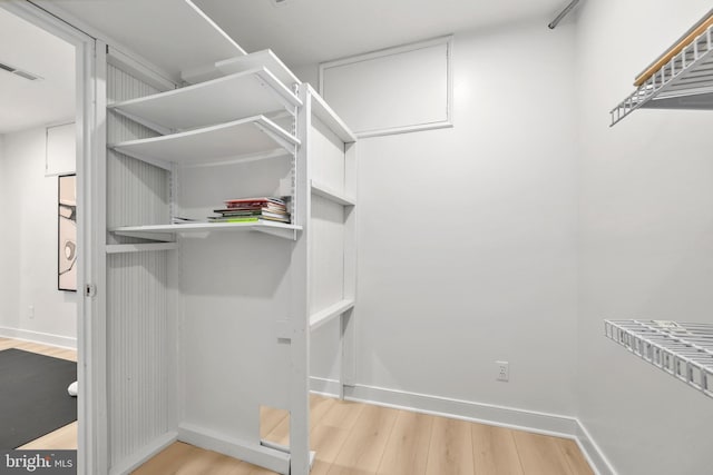 walk in closet featuring light hardwood / wood-style floors