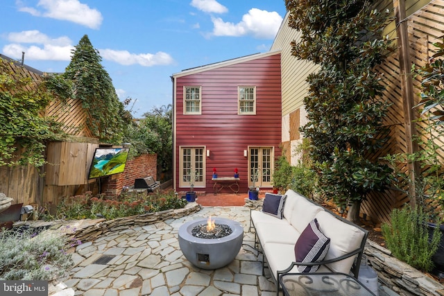 view of patio / terrace featuring an outdoor fire pit and french doors