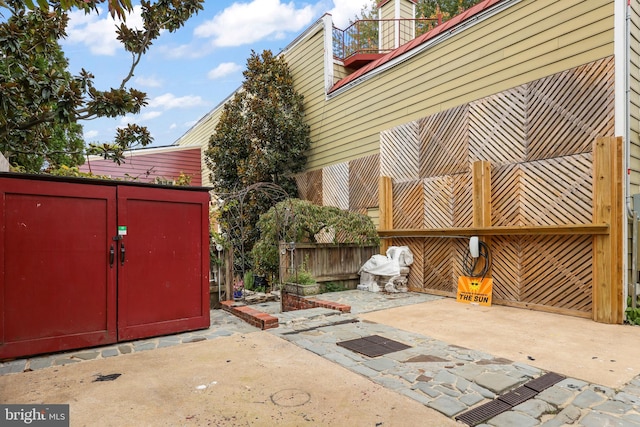 view of patio featuring a shed