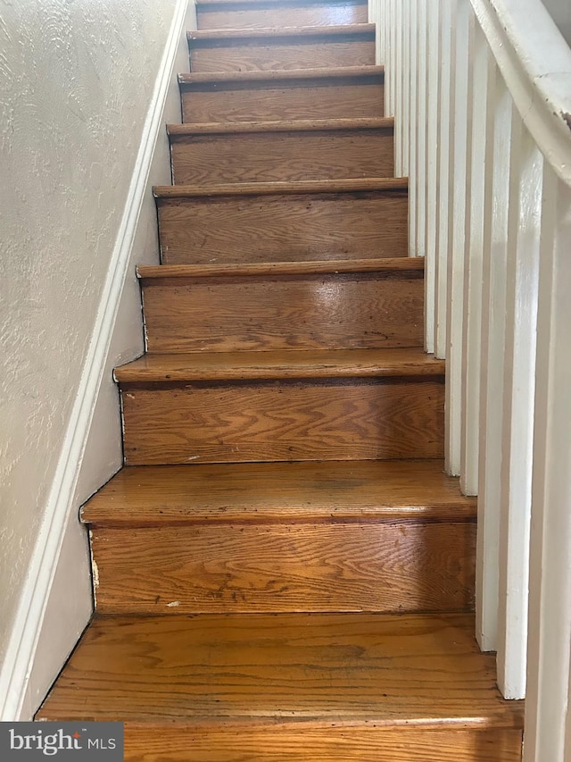 staircase with wood-type flooring