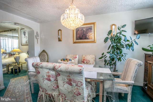 1144 E Slocum St, Philadelphia, PA 19150 - carpeted dining area featuring a textured ceiling, a chandelier, and arched walkways