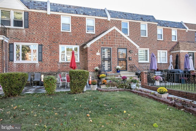1144 E Slocum St, Philadelphia, PA 19150 - view of property featuring brick siding, a high end roof, and a patio area