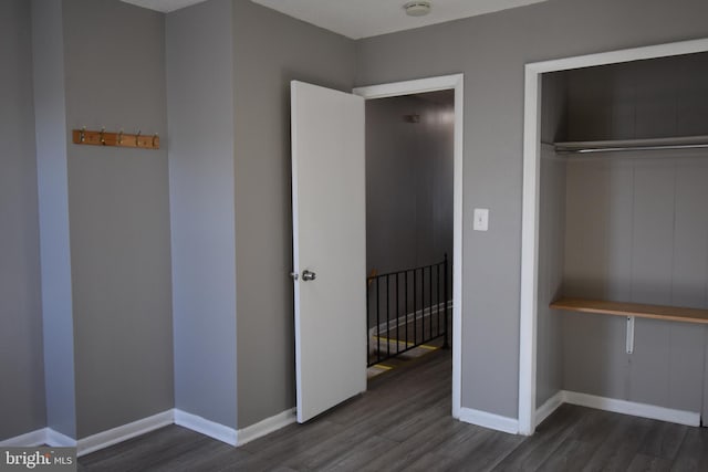 unfurnished bedroom featuring dark hardwood / wood-style floors and a closet