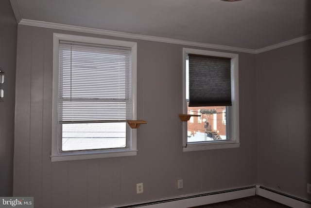 empty room with a baseboard radiator, ornamental molding, and wood walls