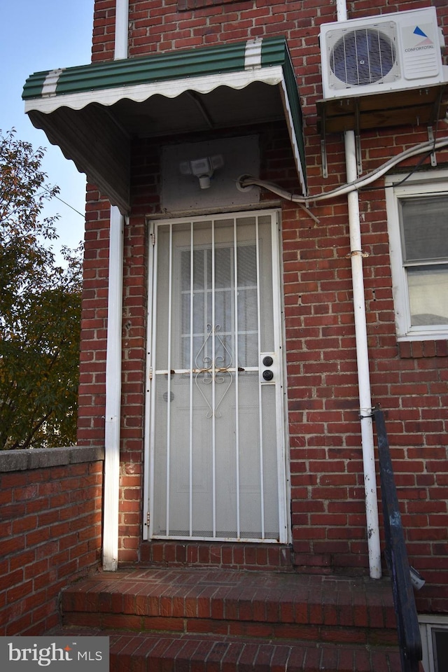 doorway to property with ac unit