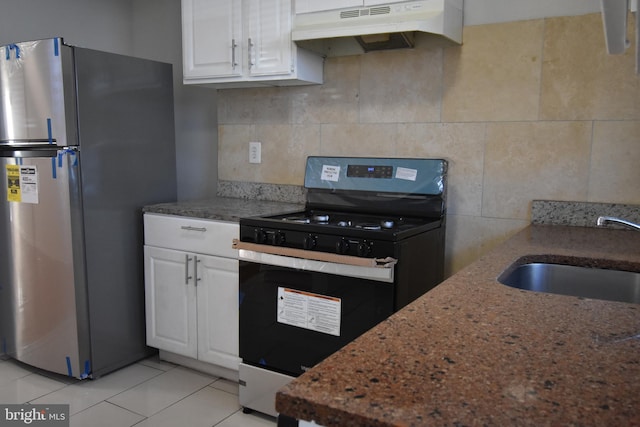 kitchen featuring sink, light tile patterned flooring, stainless steel fridge, white cabinetry, and gas range