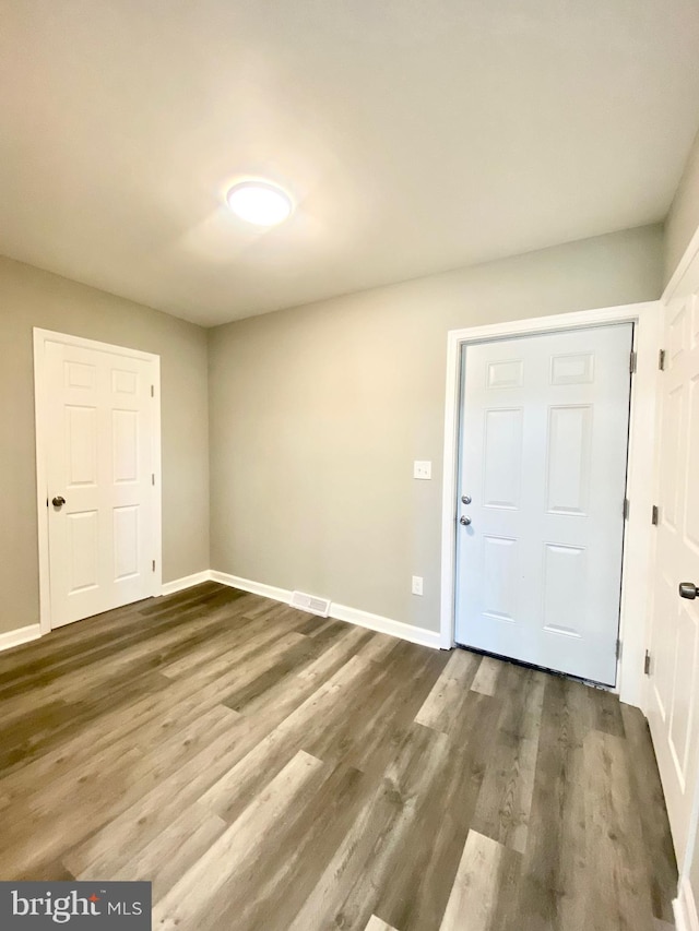 foyer entrance with dark hardwood / wood-style flooring