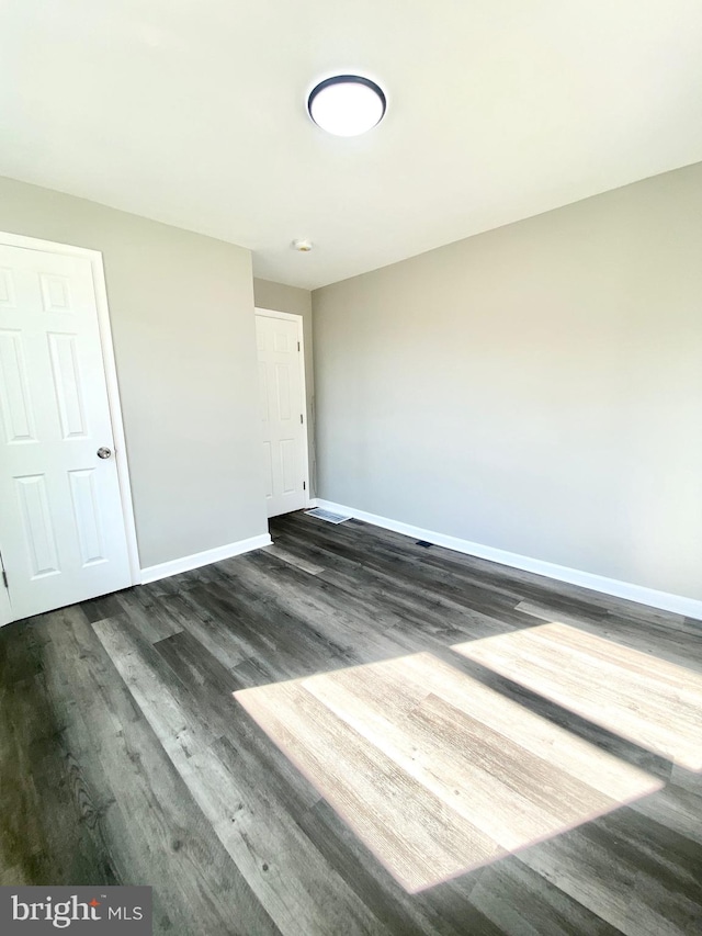 empty room featuring dark hardwood / wood-style floors