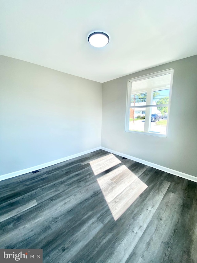 empty room featuring dark wood-type flooring