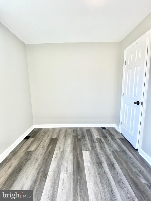 spare room featuring dark hardwood / wood-style floors