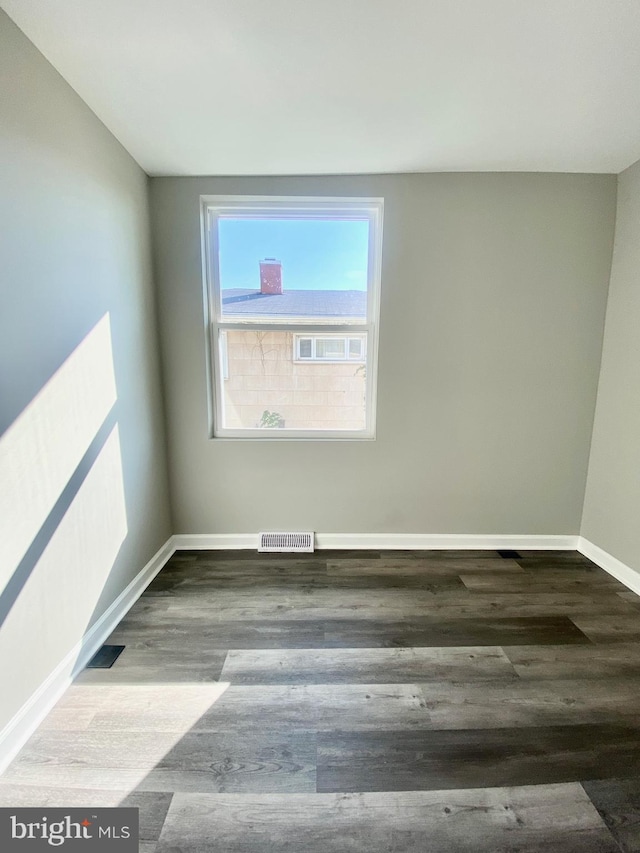 spare room with wood-type flooring