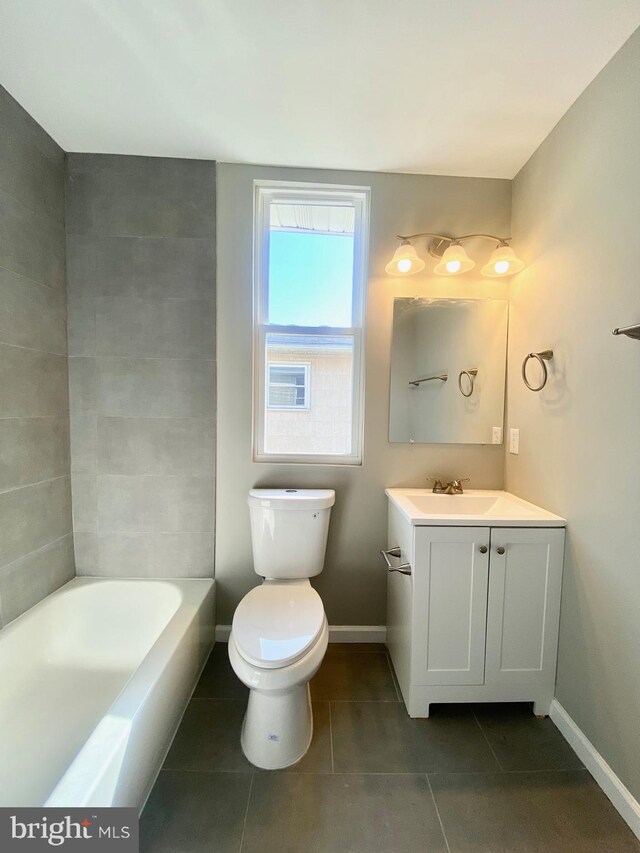 bathroom with vanity, toilet, a bath, and tile patterned flooring