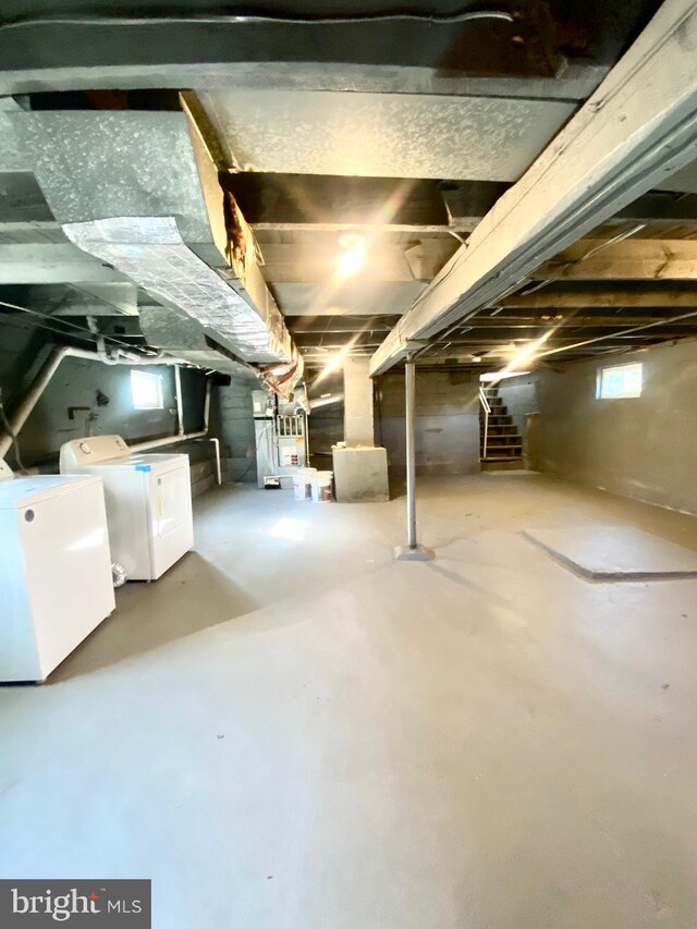 basement with white fridge and separate washer and dryer