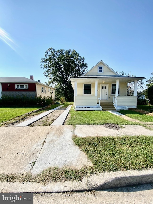 bungalow-style home with a front yard and a porch