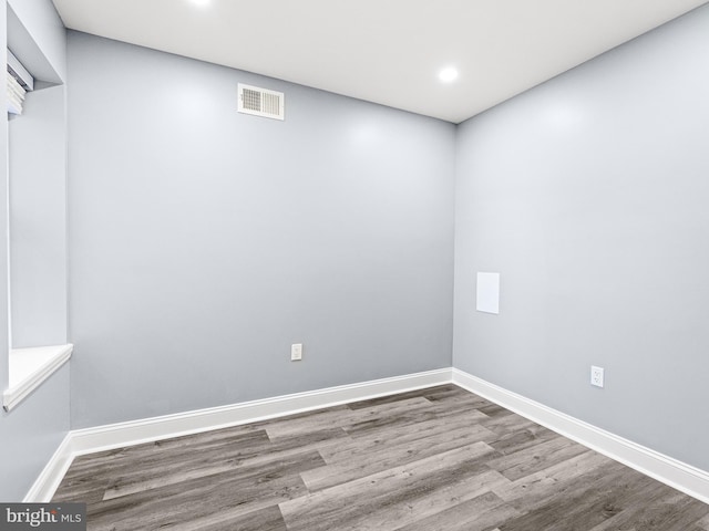 unfurnished room with hardwood / wood-style flooring