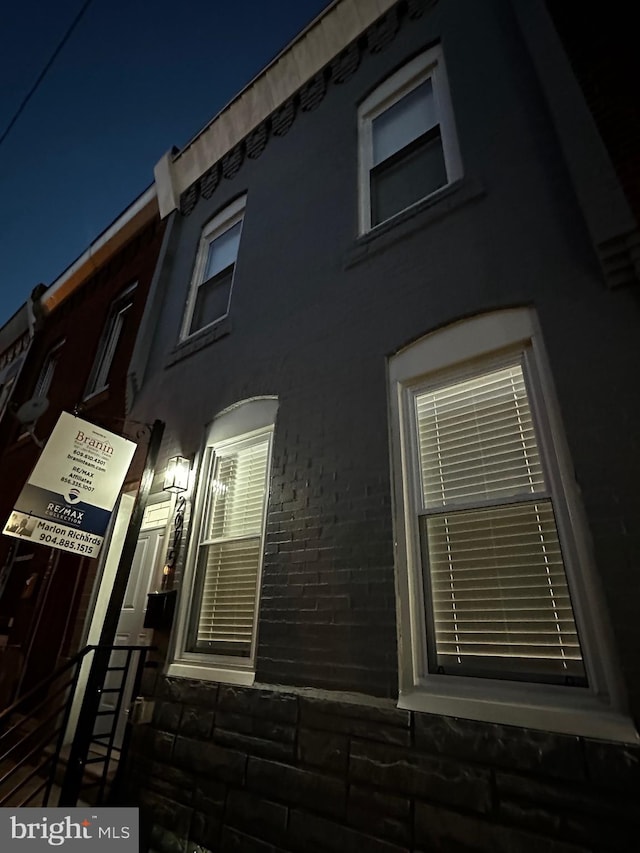 view of property exterior at night