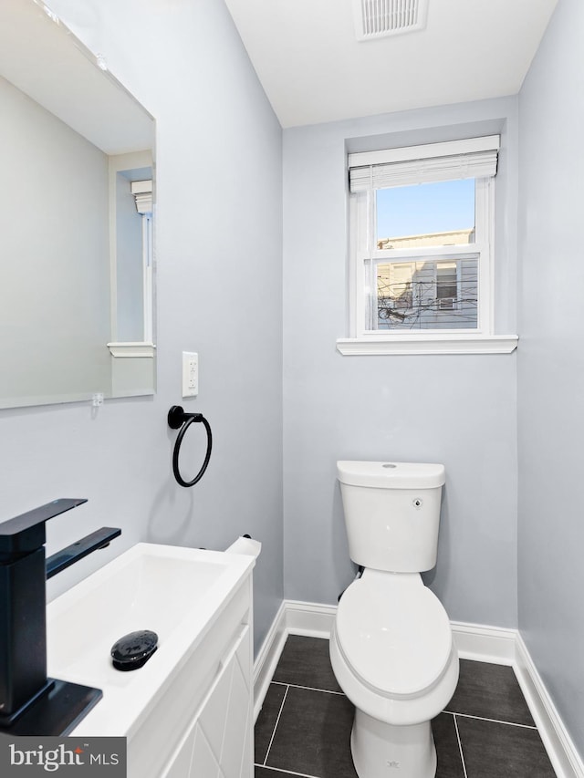 bathroom featuring toilet, vanity, and tile patterned floors