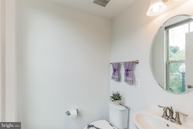 bathroom featuring toilet and sink