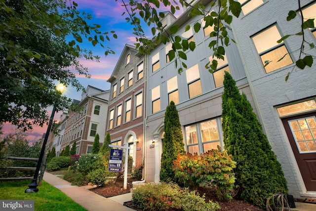 view of outdoor building at dusk