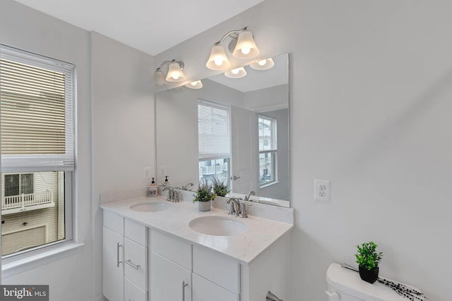 bathroom featuring vanity and toilet