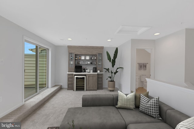 living room featuring light carpet, bar area, and beverage cooler