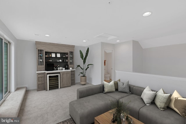 living room with light colored carpet, wine cooler, indoor bar, and plenty of natural light