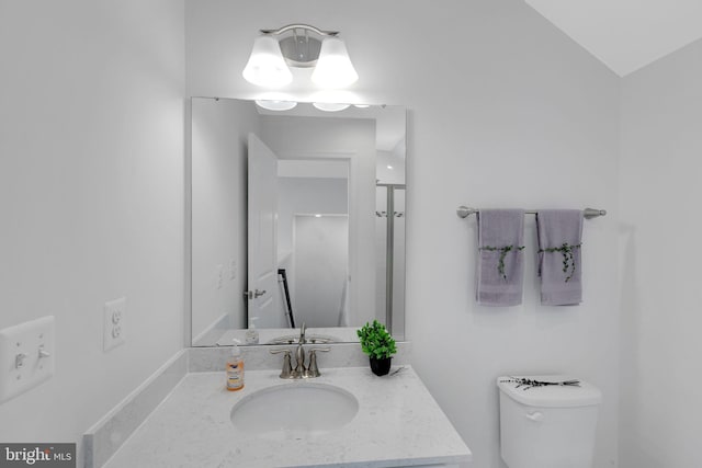 bathroom with vanity, toilet, lofted ceiling, and an enclosed shower