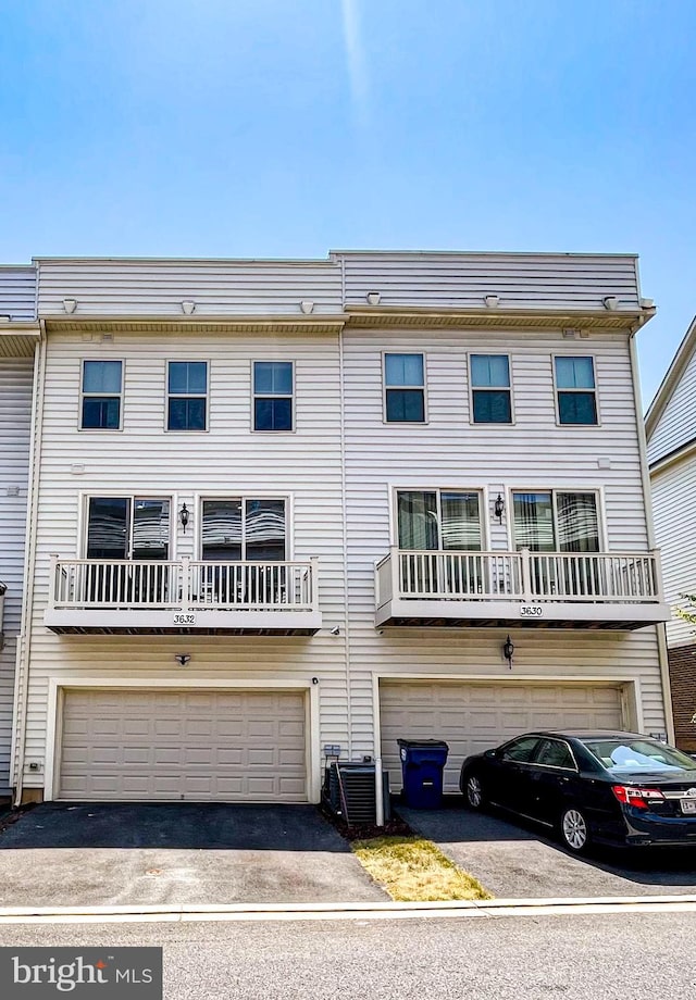 view of front of home featuring a balcony and a garage