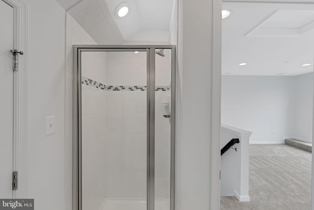 bathroom featuring a shower with door