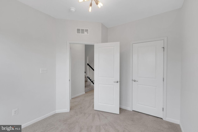 unfurnished bedroom with light carpet