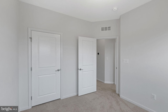 unfurnished bedroom with light carpet