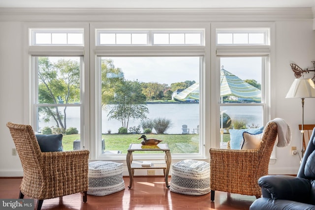 interior space featuring a water view, ornamental molding, and hardwood / wood-style floors