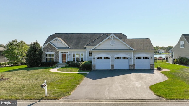 view of front of house featuring a front yard and a garage