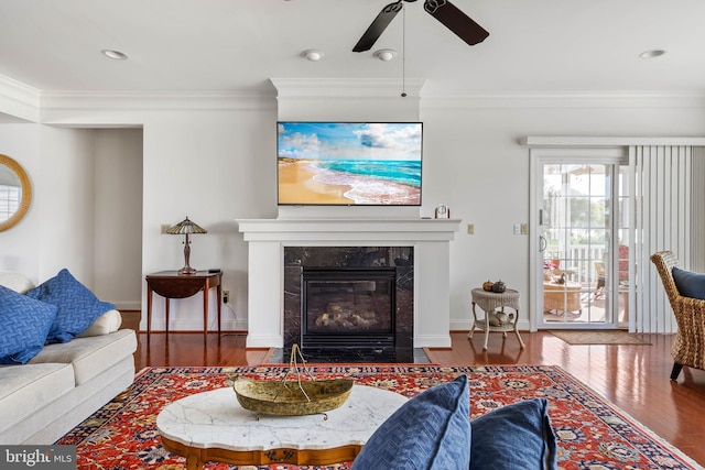 living room featuring ornamental molding, hardwood / wood-style flooring, and ceiling fan