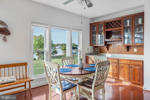 dining space with wood-type flooring and ceiling fan