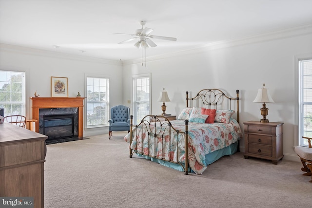 bedroom featuring multiple windows, ornamental molding, and ceiling fan