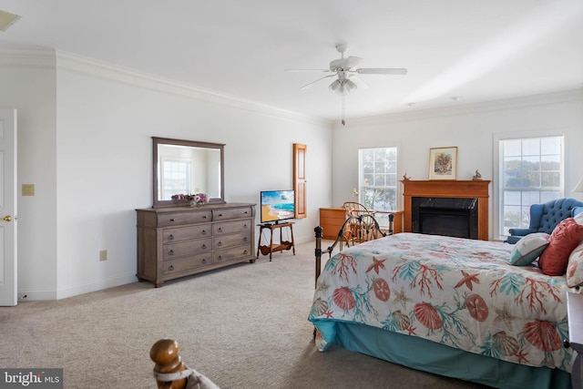 carpeted bedroom featuring ornamental molding, a fireplace, and ceiling fan