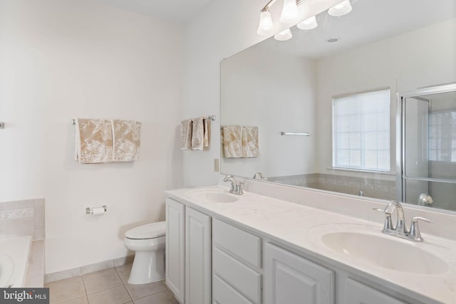 bathroom featuring vanity, toilet, tile patterned floors, and a bathing tub