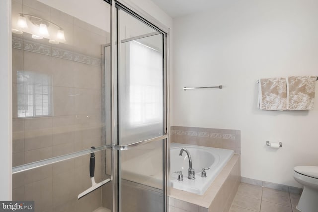 bathroom with toilet, plus walk in shower, and tile patterned flooring