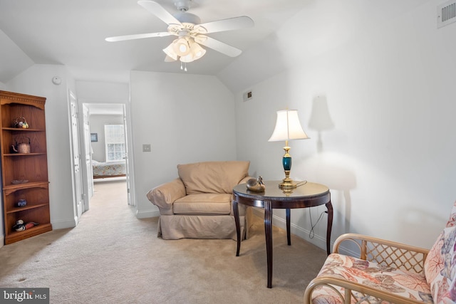 sitting room featuring light carpet, ceiling fan, and vaulted ceiling